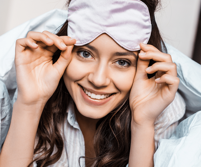 Woman with a sleep mask smiling
