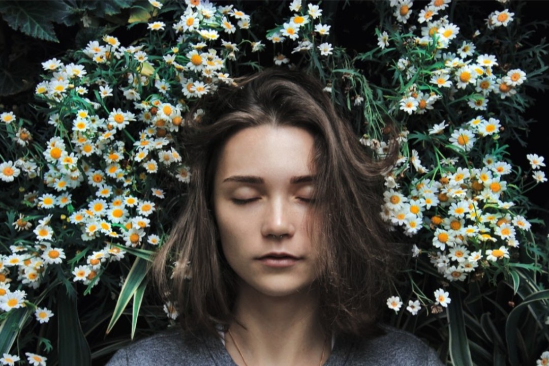 woman sleeping on flowers