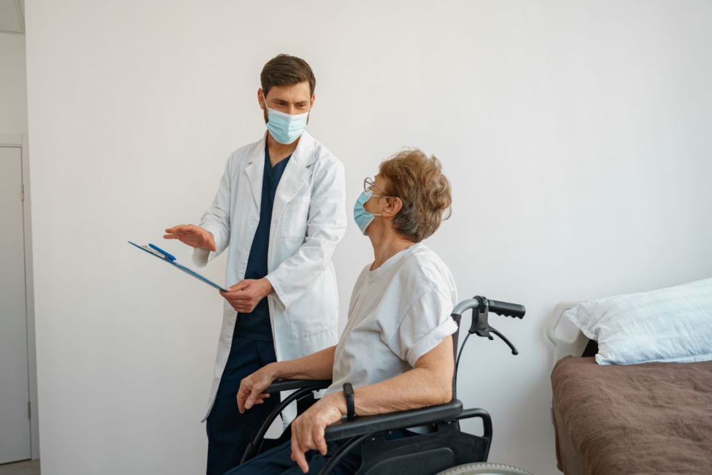 A doctor talking to a patient in a wheelchair.